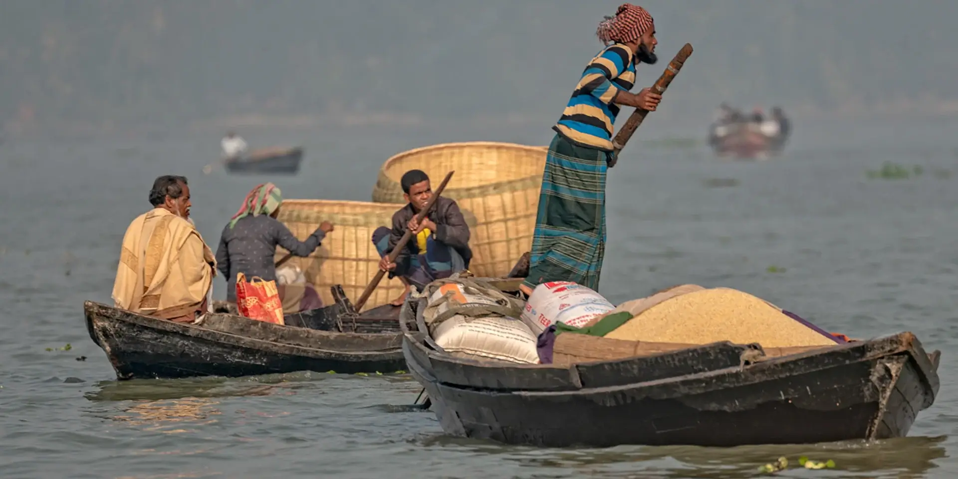 Barisal floating rice market boatman
